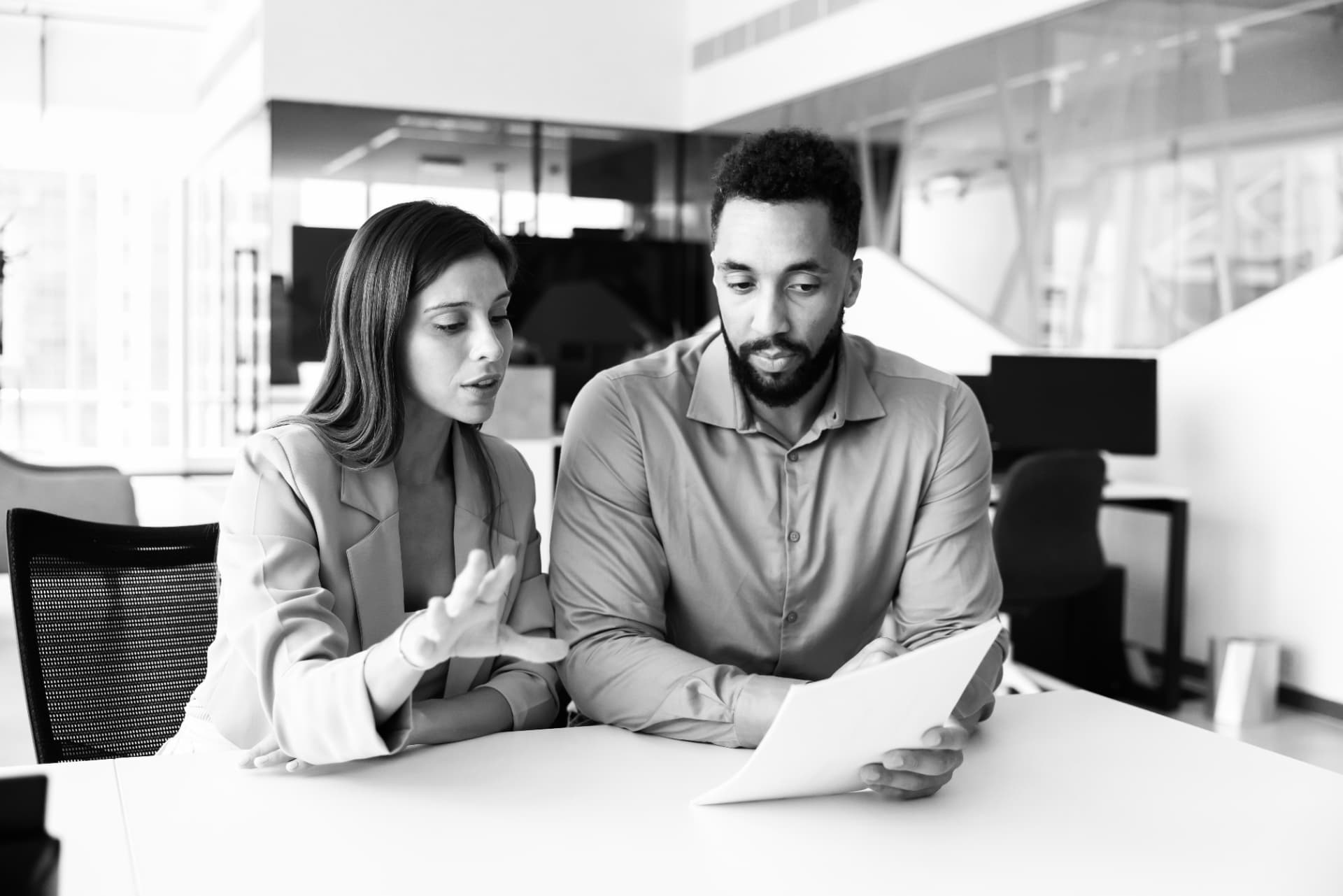 Two colleagues reviewing a baseline report together